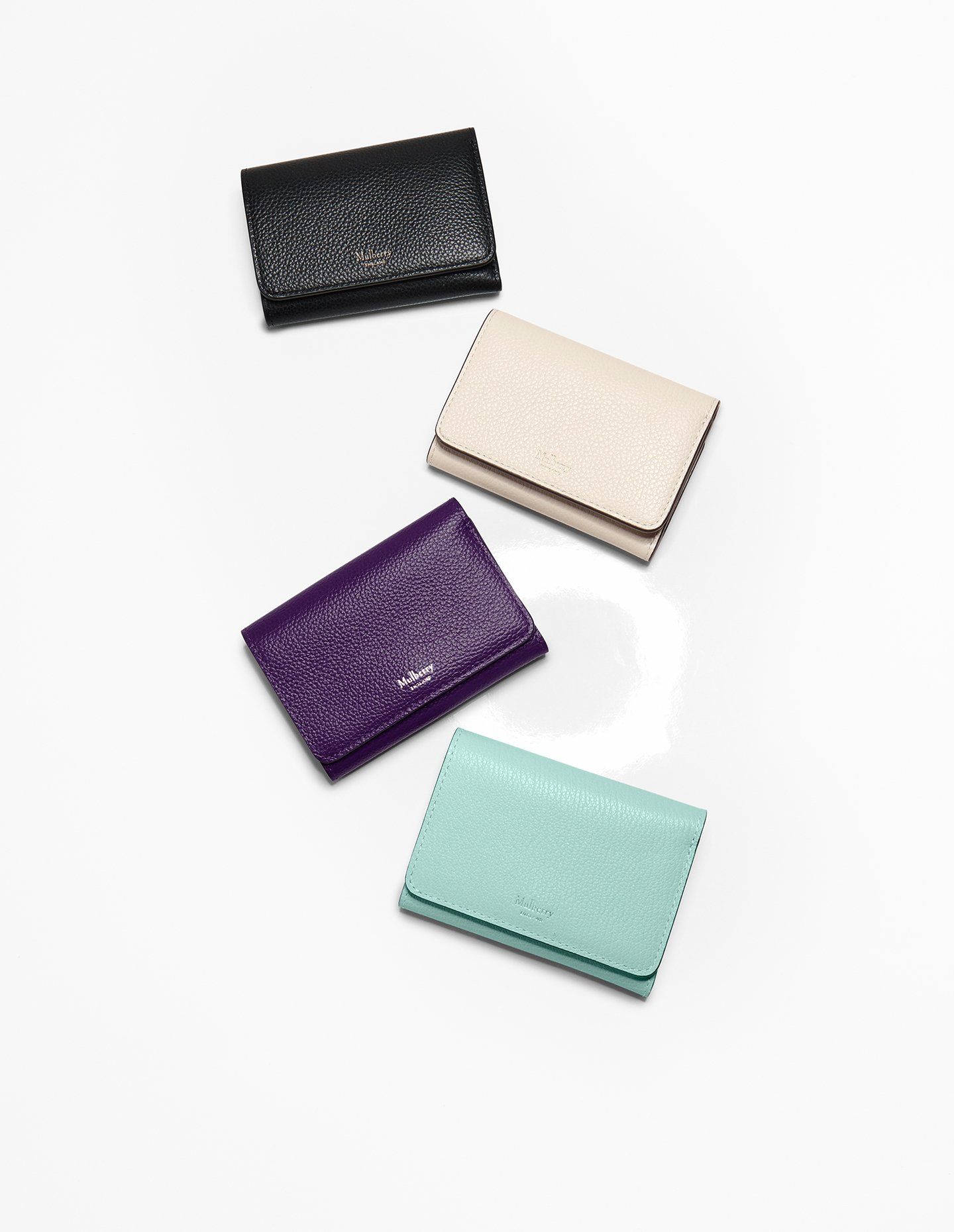 Four Mulberry wallets in black, purple, chalk and acrylic green